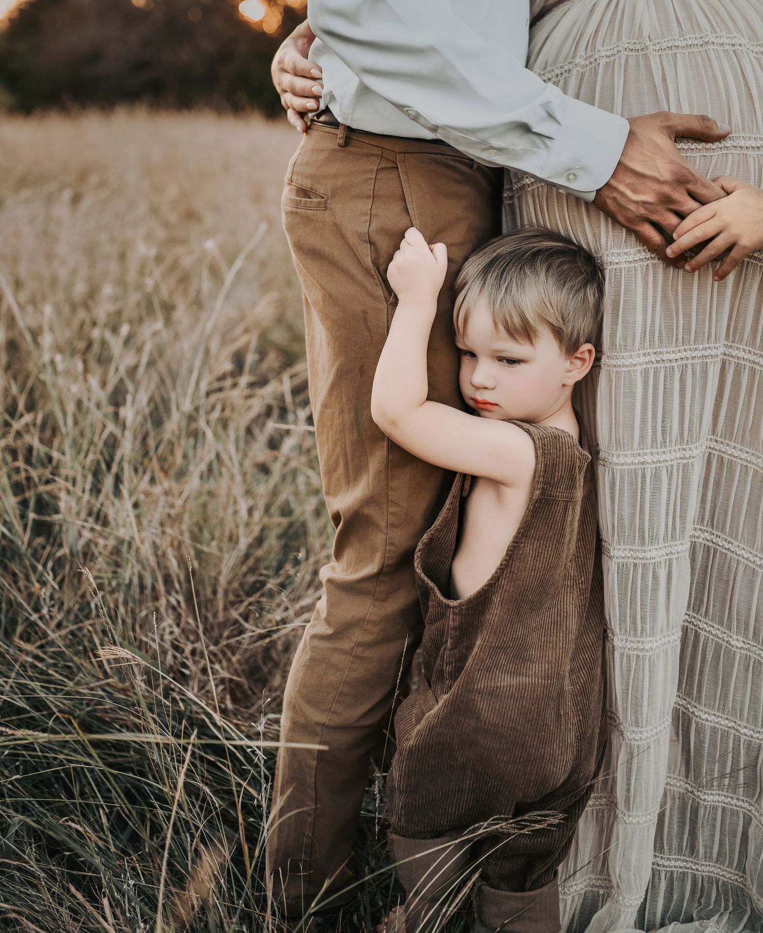 Candid maternity photos documenting a family before welcoming their newest baby boy