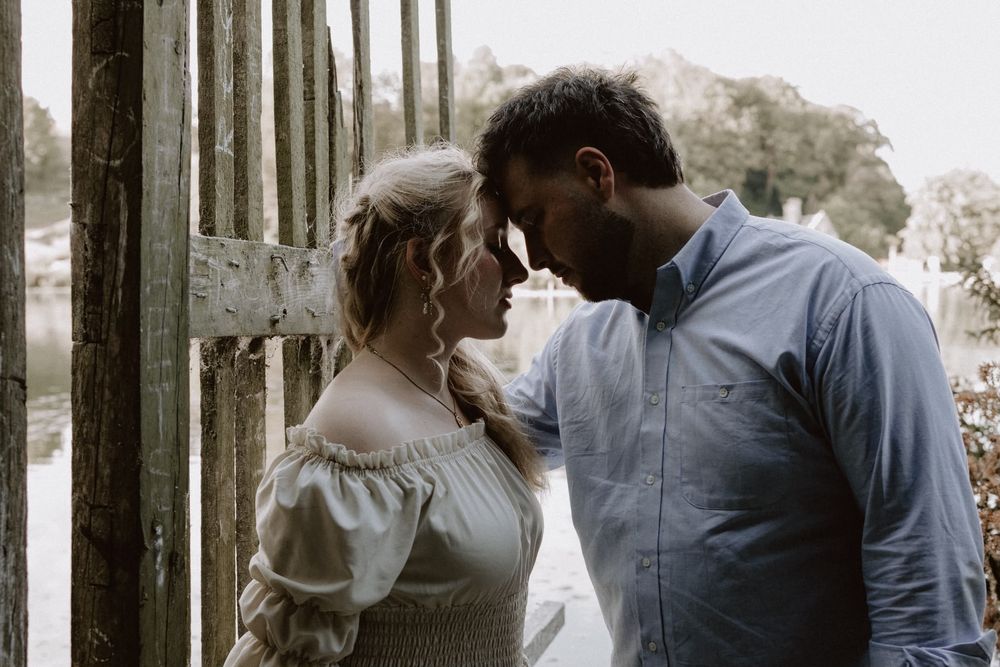 Couple looking in to each others eyes by fence