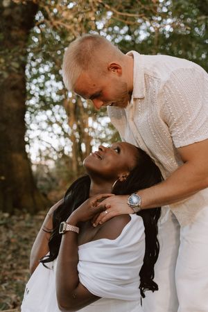 Close-up candid moment of a couple laughing and cuddling together
