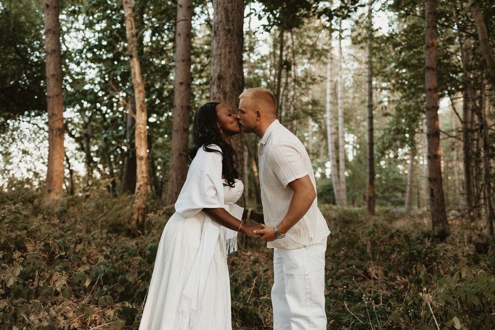 Couple holding hands together on a woodland path