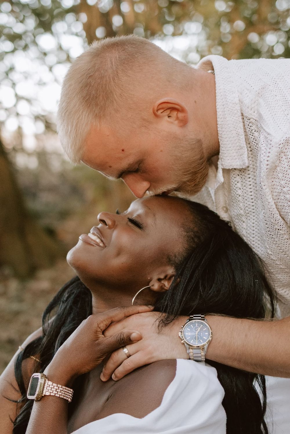 Close-up candid moment of a couple laughing and cuddling together