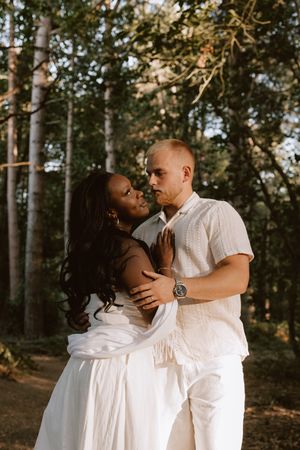 Couple looking at each other in woodland
