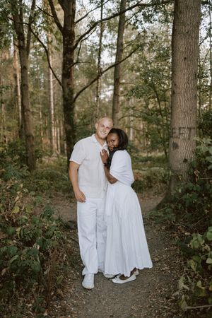 Couple smiling at camera in relaxed woodland photoshoot