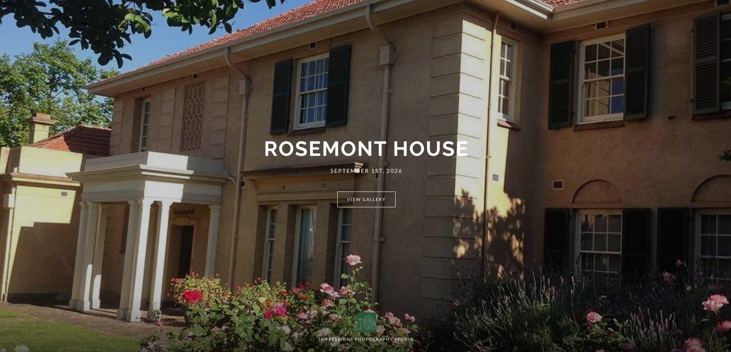 Rosemont House historic brick building with lush garden roses and green trees in a charming heritage property setting.