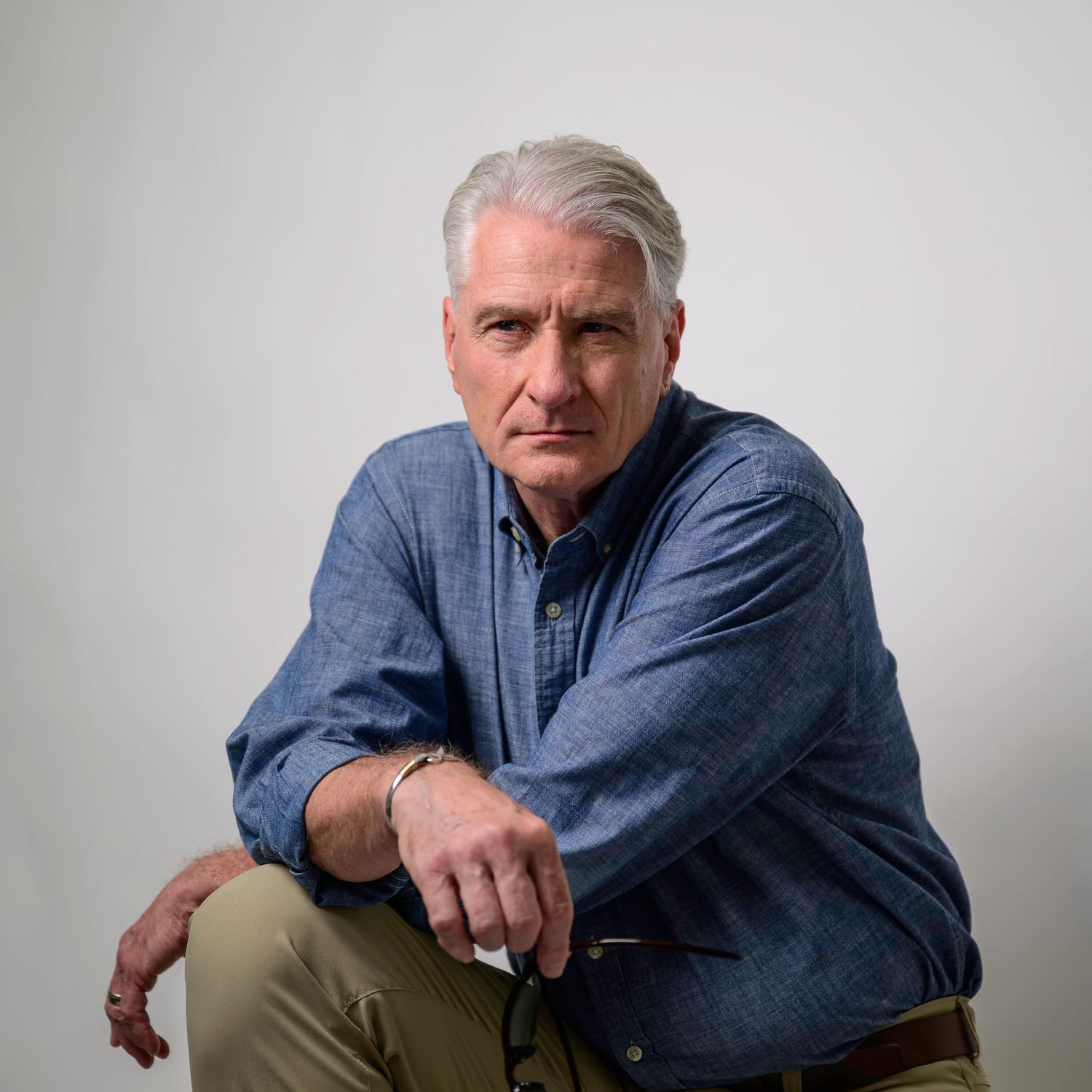 Professional branding portrait of a mature man seated in a studio