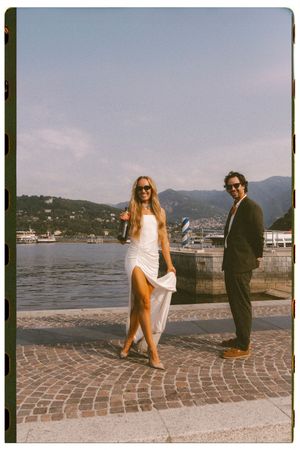 Stylish bride and groom sharing a joyful moment during their intimate elopement on Lake Como, Italy