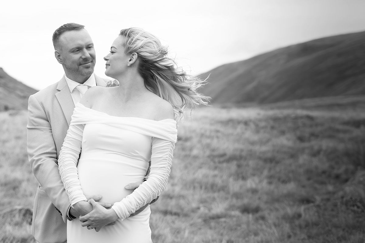 Black and white photo of a couple embracing during their  Lake District elopement wedding celebration