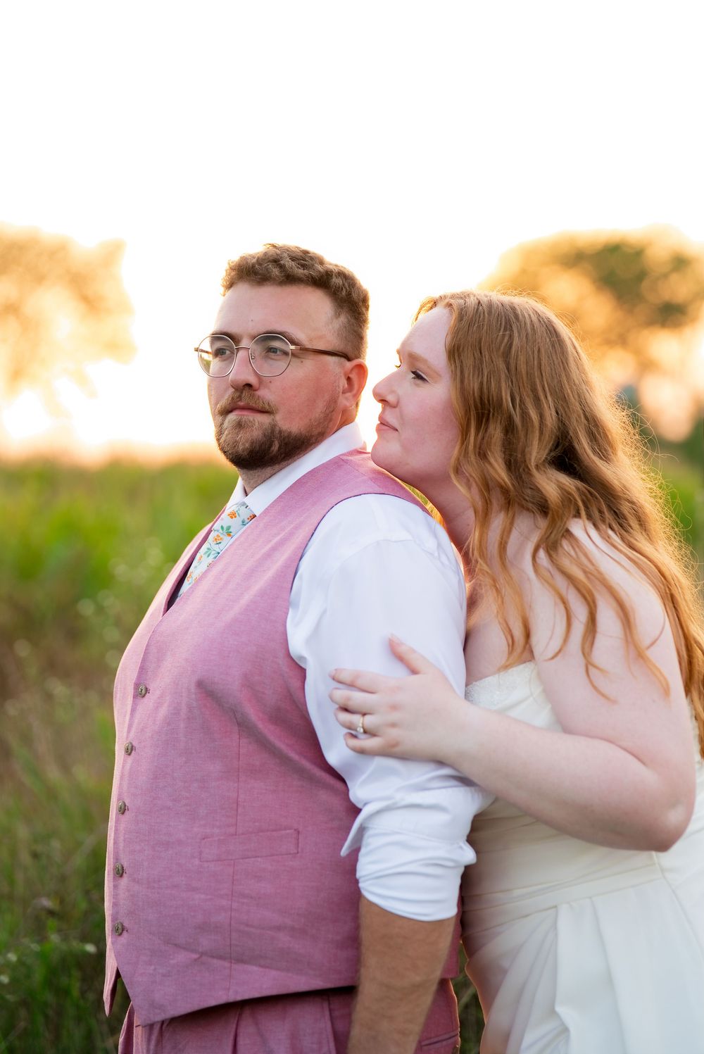 Romantic golden hour wedding portrait of a bride and groom in a sunlit field in Wayland, Michigan.