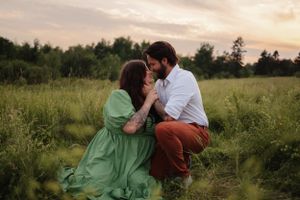 Intimate moment captured between a couple in a wildflower field during golden hour.