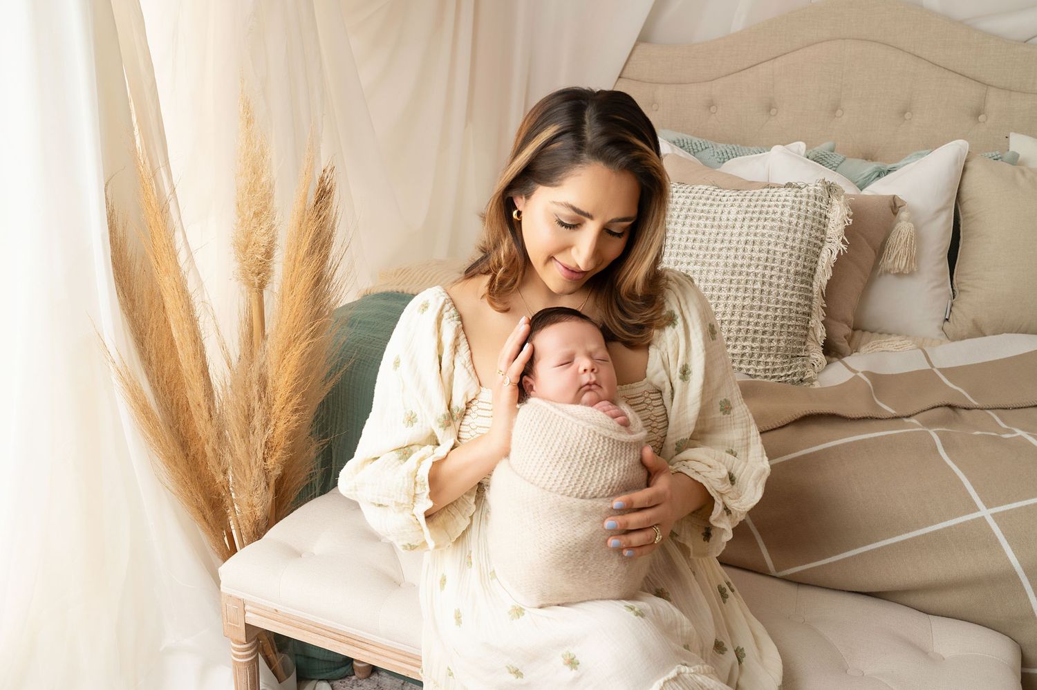 Serene maternity photography session with neutral tones and soft lighting.