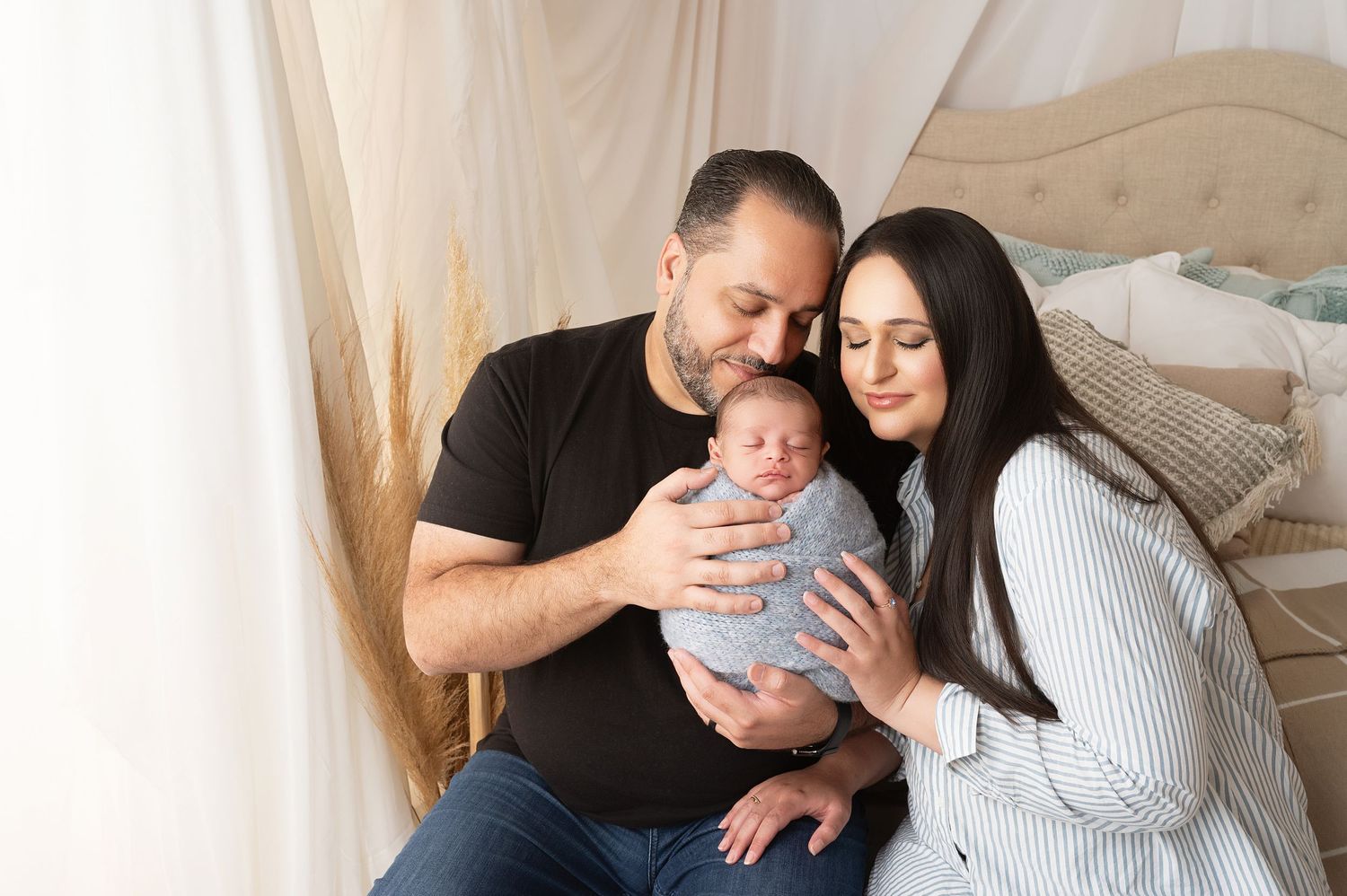 Family portrait session with newborn in soft neutral tones.
