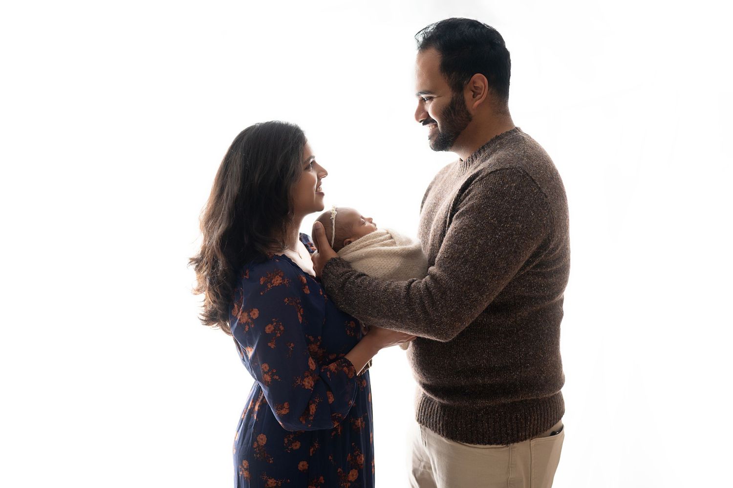 Sweet candid moment between couple during indoor photo session.