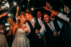 Wedding celebration at night with sparklers illuminating a joyful moment on the dance floor during reception festivities.