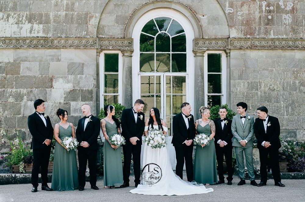 A series of wedding party portraits in formal attire standing against a stone building exterior.