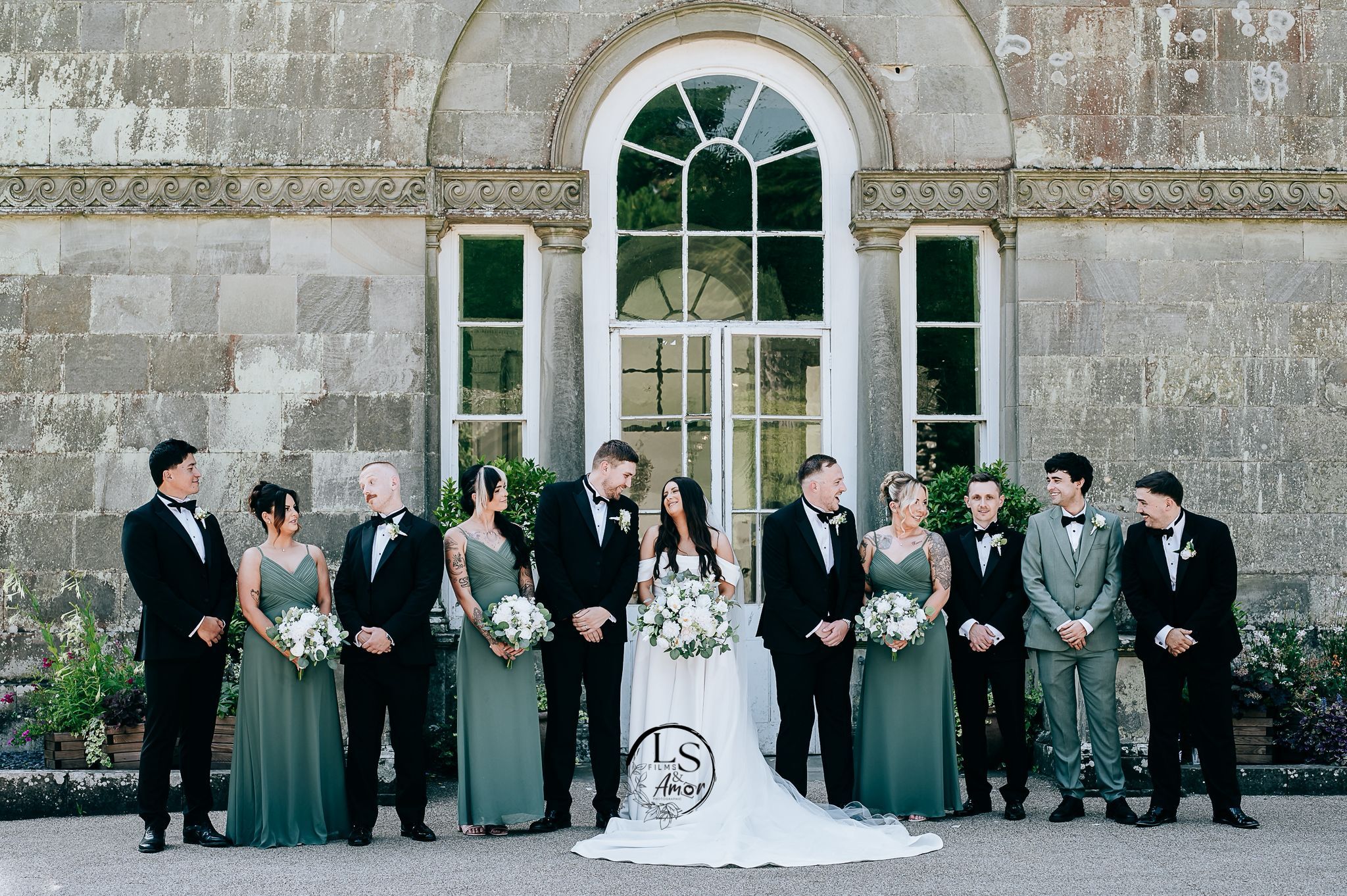 A series of wedding party portraits in formal attire standing against a stone building exterior.