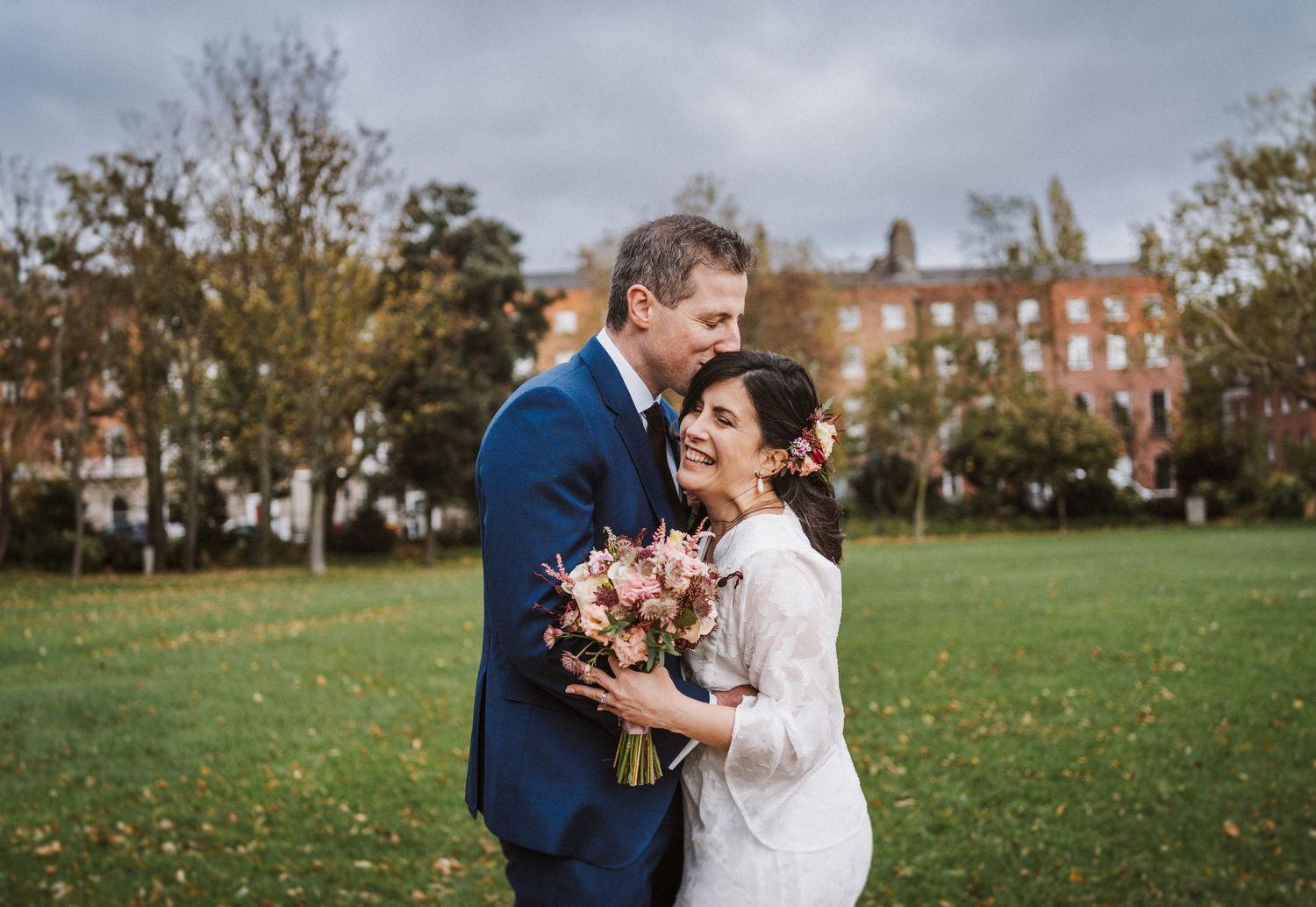 A stylish black and white wedding portrait in an urban alleyway.