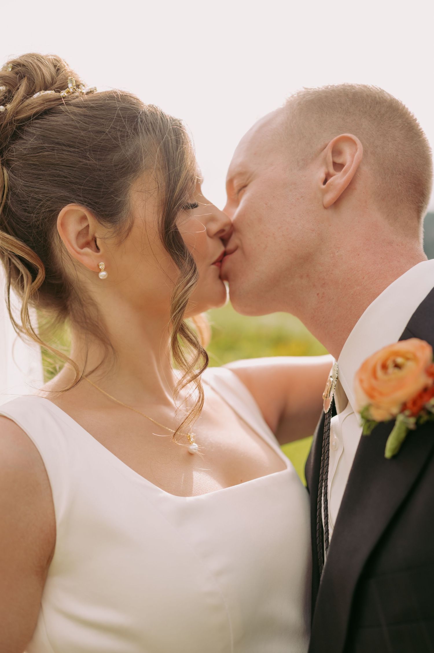 An intimate wedding portrait shows a tender moment between newlyweds.
