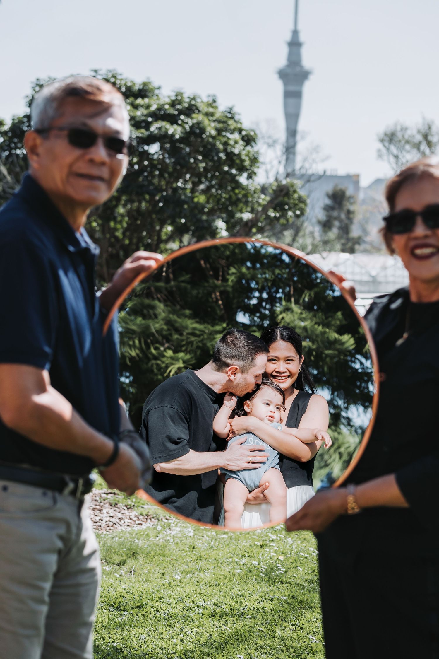 A creative mirror portrait with the Sky Tower visible in the background.