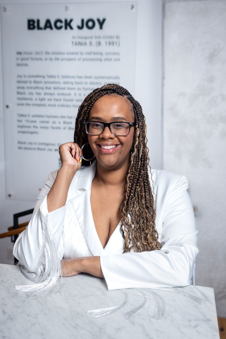 Photographer TaNia S in her Black Joy exhibition in Washington DC Arena Social Arts Club Drew Gallery