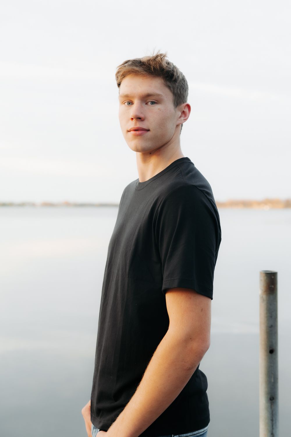 Portrait series against white background featuring black t-shirt and casual styling.