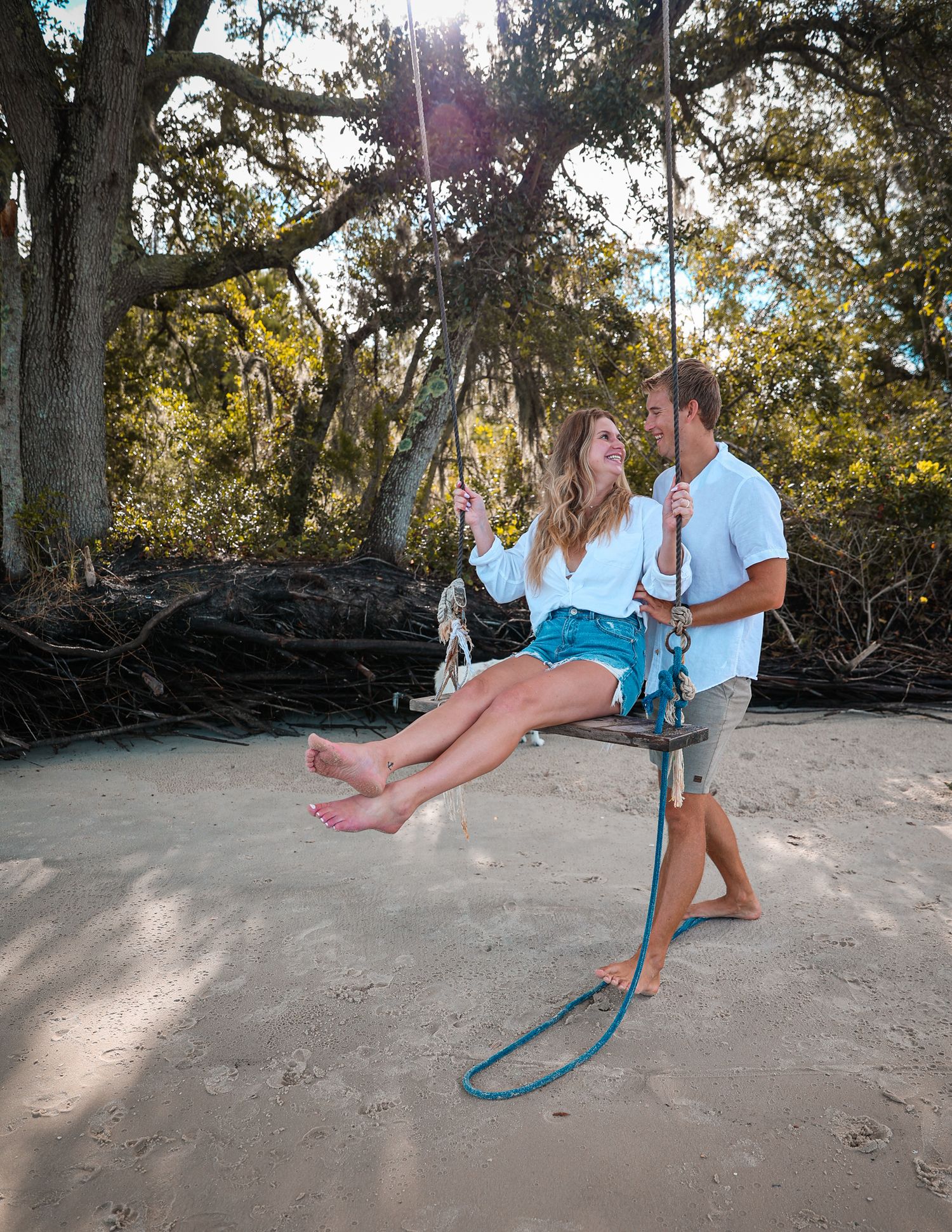 Series of playful beach swing photos showing a couple swaying back and forth in bright sunlight.