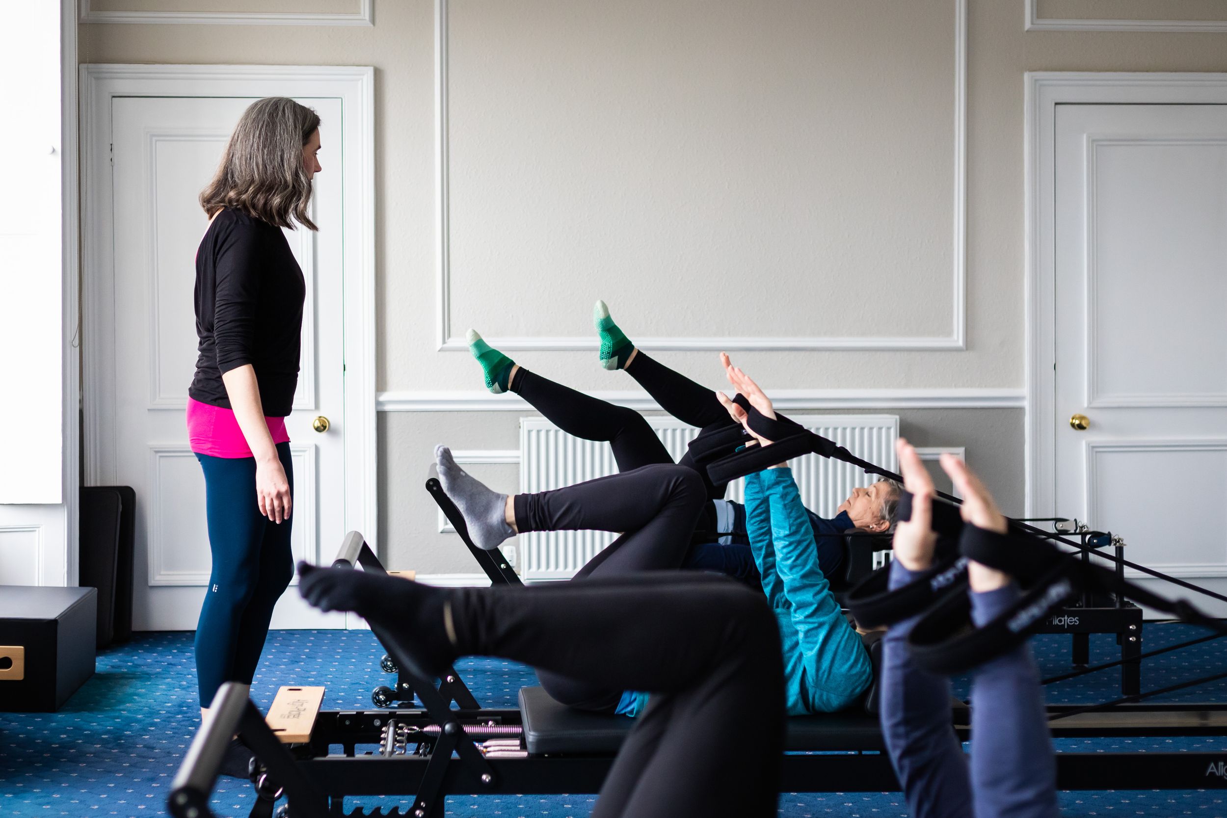 A series of yoga poses demonstrated on a blue exercise mat showing stretching and flexibility movements.