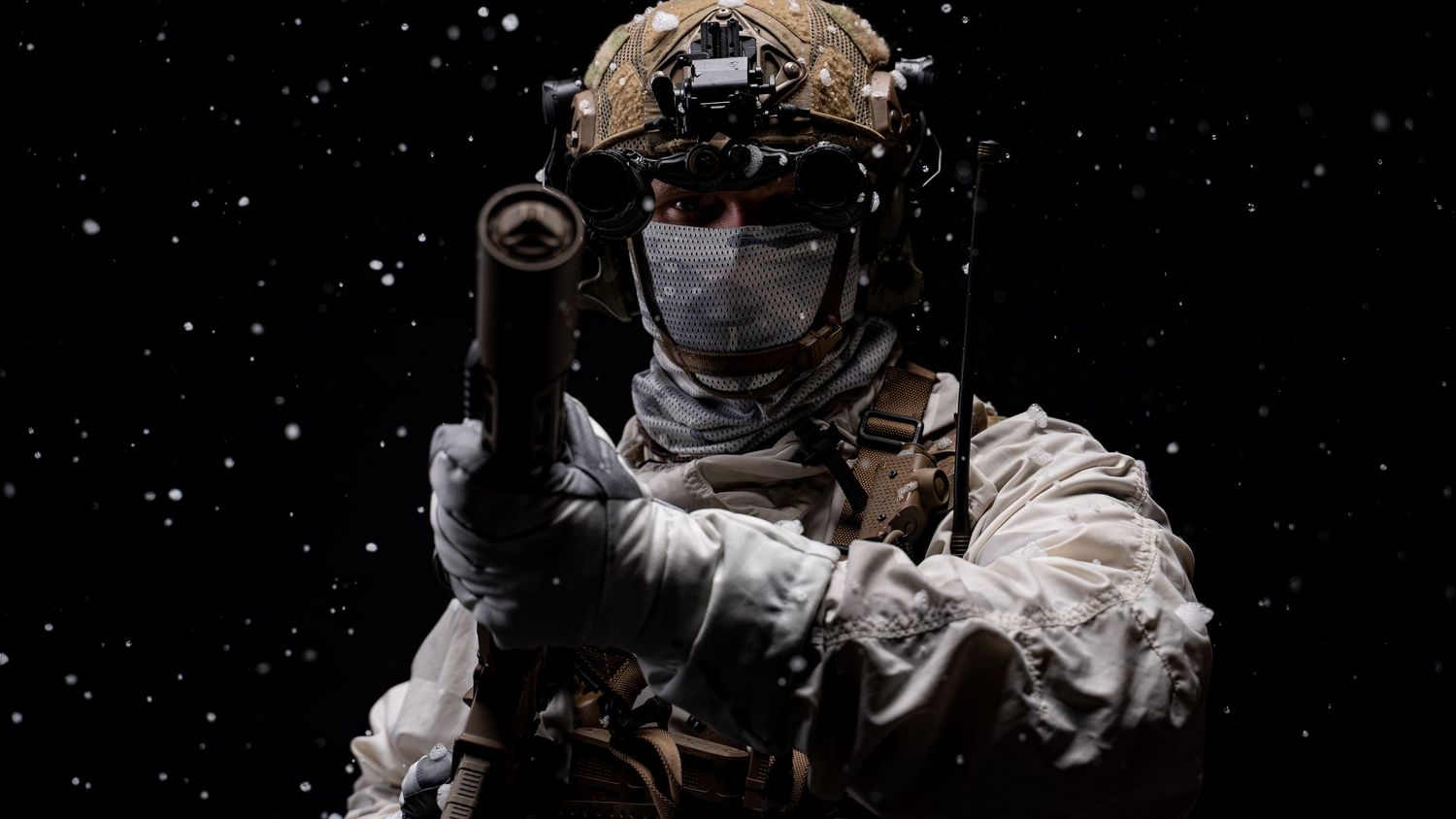 Close up of a police officer in tactical gear with night vision goggles against dark background.