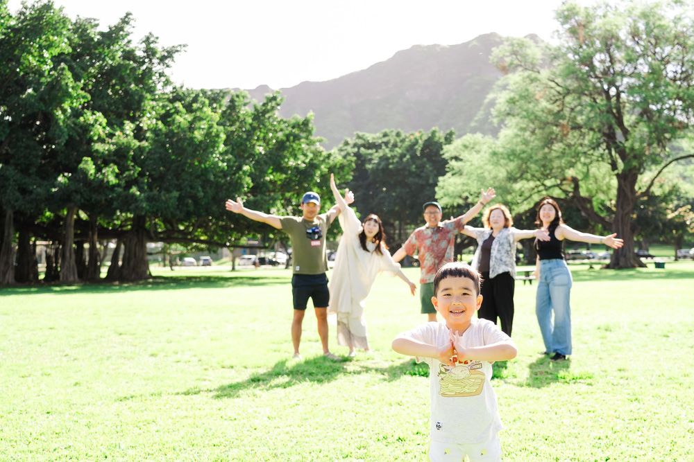 People enjoying outdoor activities and yoga poses in a scenic green park on a sunny day.