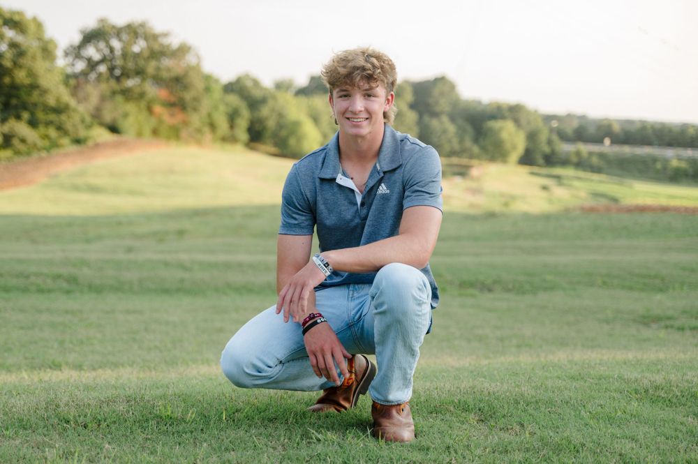 Portrait of young man in green, colorful field