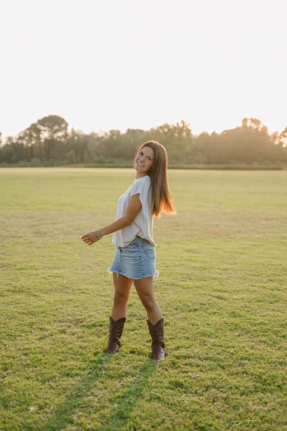 Portrait of girl spinning in field during golden hour
