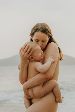 A tender moment captured in a series of intimate black and white photographs showing parent and baby embracing.