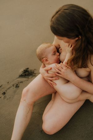 A tender and intimate artistic portrait series showing a parent and baby in muted neutral tones.