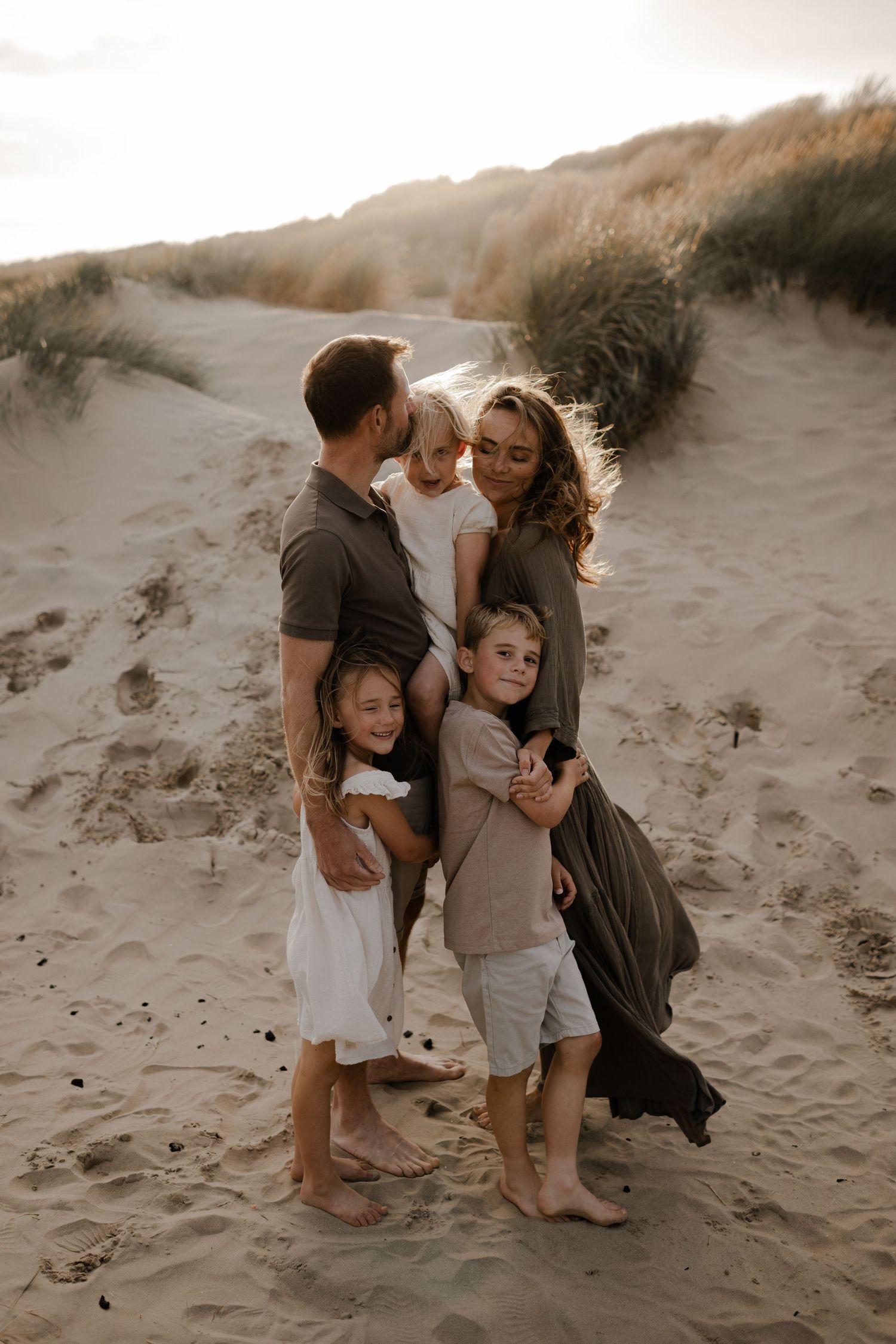 A couple with their children on the beach Kent family photographer