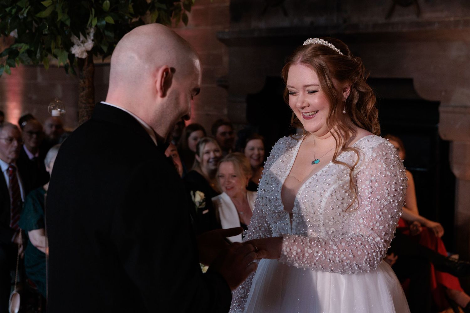 A tender moment captured in black and white as a couple embraces during their wedding ceremony.