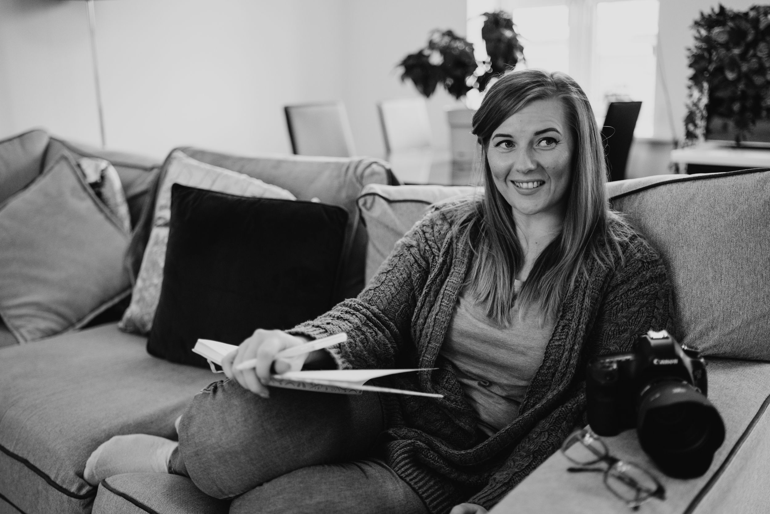 staffordshire photographer sat taking notes with her camera