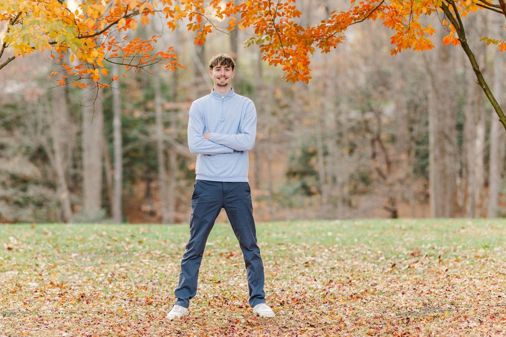 High school, male athlete posing during family portrait fall session in Vienna, Virginia