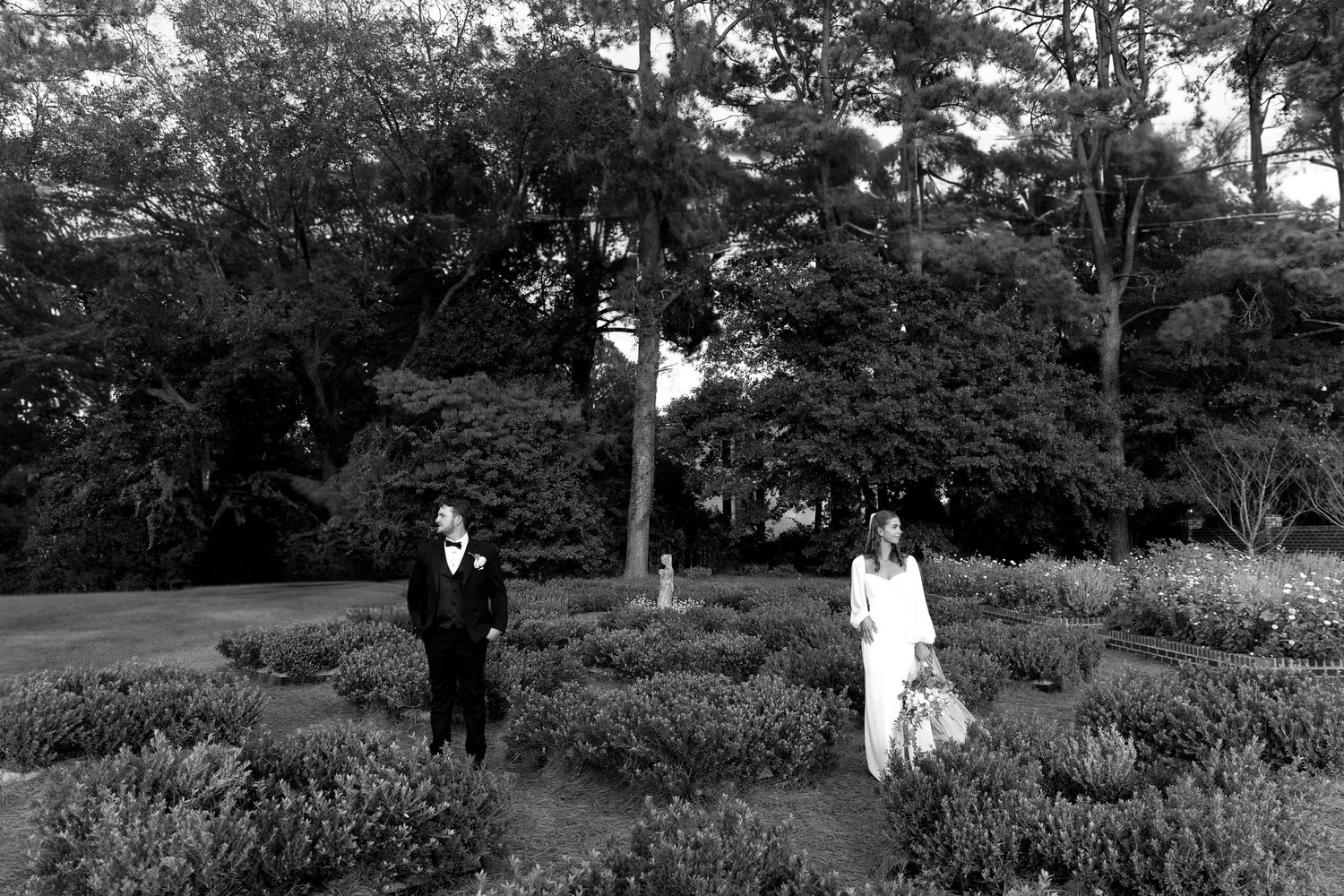 A series of black and white photographs showing people walking through a tranquil garden landscape with trees and paths.