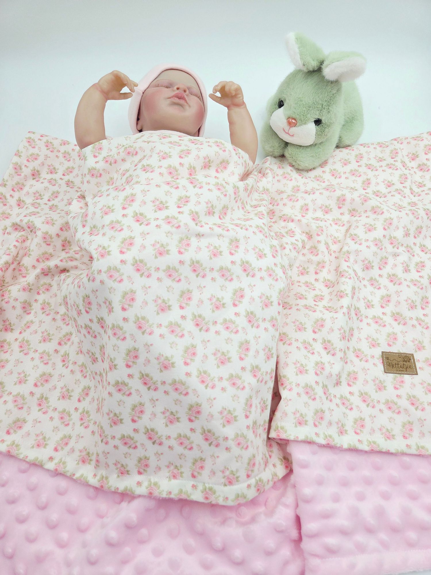 Floral print baby blanket paired with pink minky fabric showing texture details.