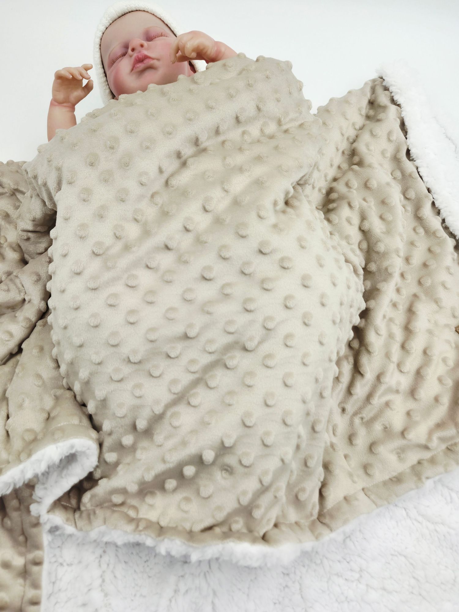 Soft cream-colored minky dot blanket with raised bubble texture.