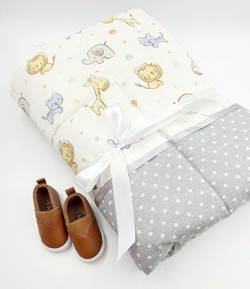 Baby nursery bedding set with animal prints in beige and gray polka dots featuring matching leather booties.