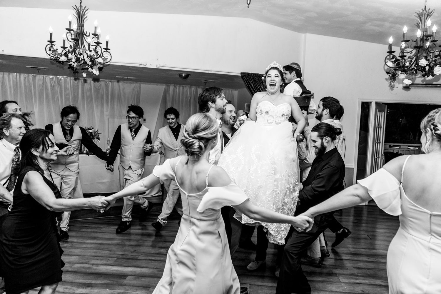 Candid photograph of a traditional Jewish wedding chair dance during the reception.