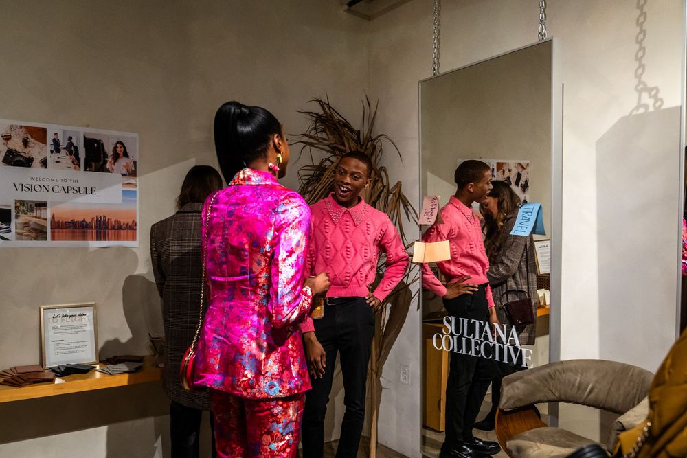 Bright pink event space with retail displays and decorative lighting.