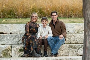 A group poses casually on stone steps during an outdoor photo session.
