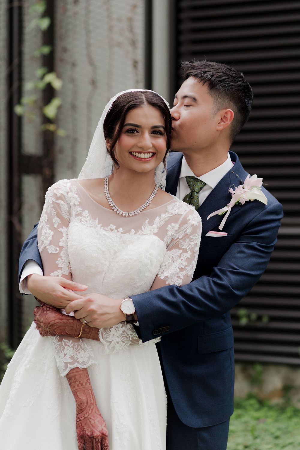 Romantic wedding portrait session featuring elegant lace dress and navy suit.