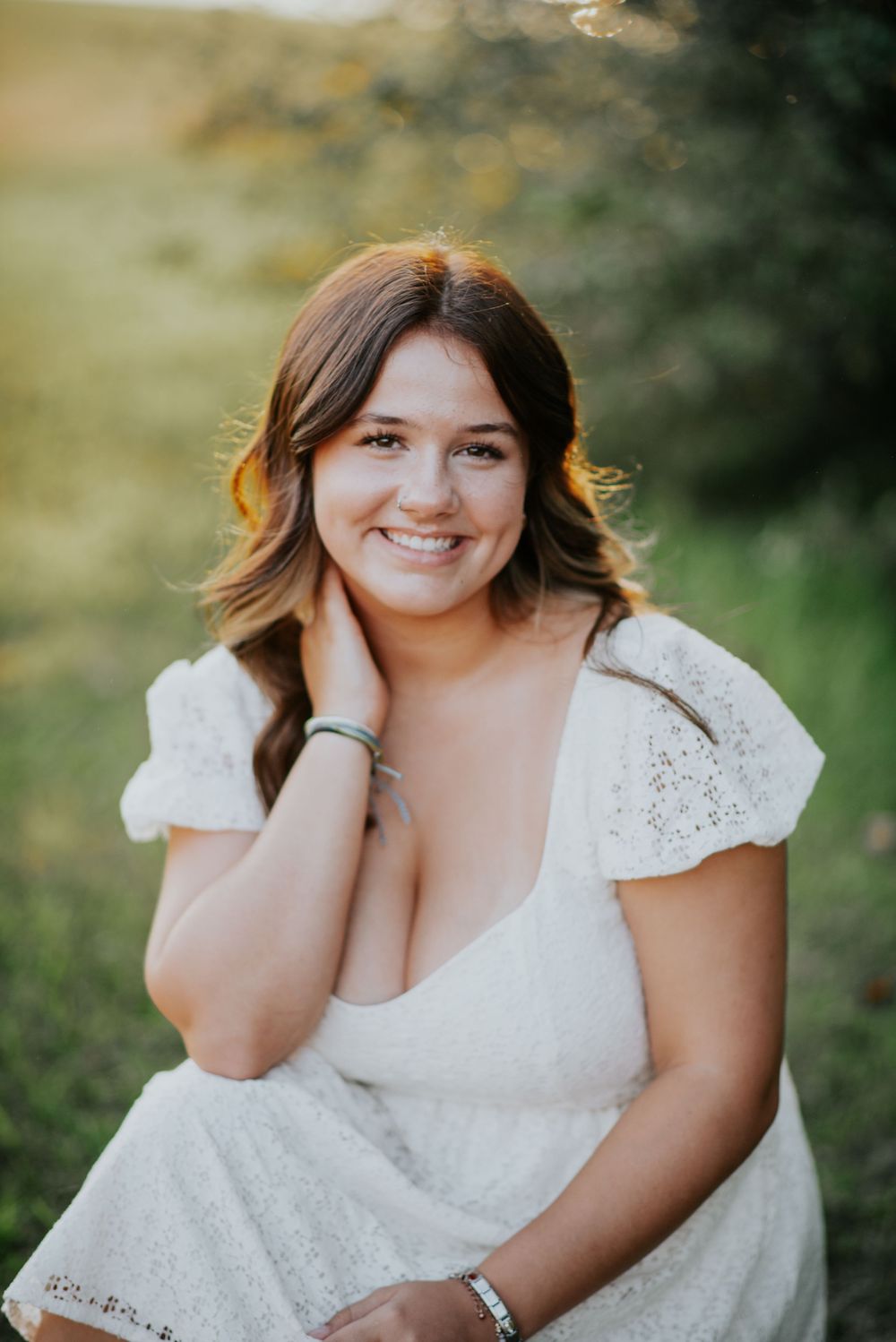 Senior portrait session in golden sunlight with white eyelet dress.