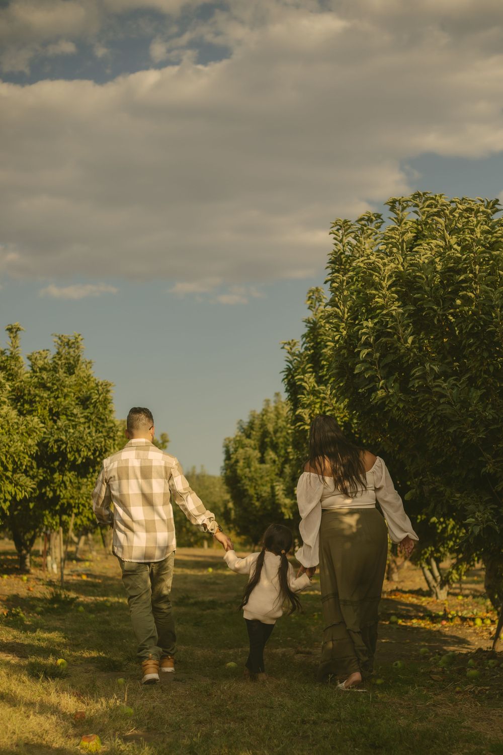 Family walking hand in hand enjoying the only child life before the new baby comes