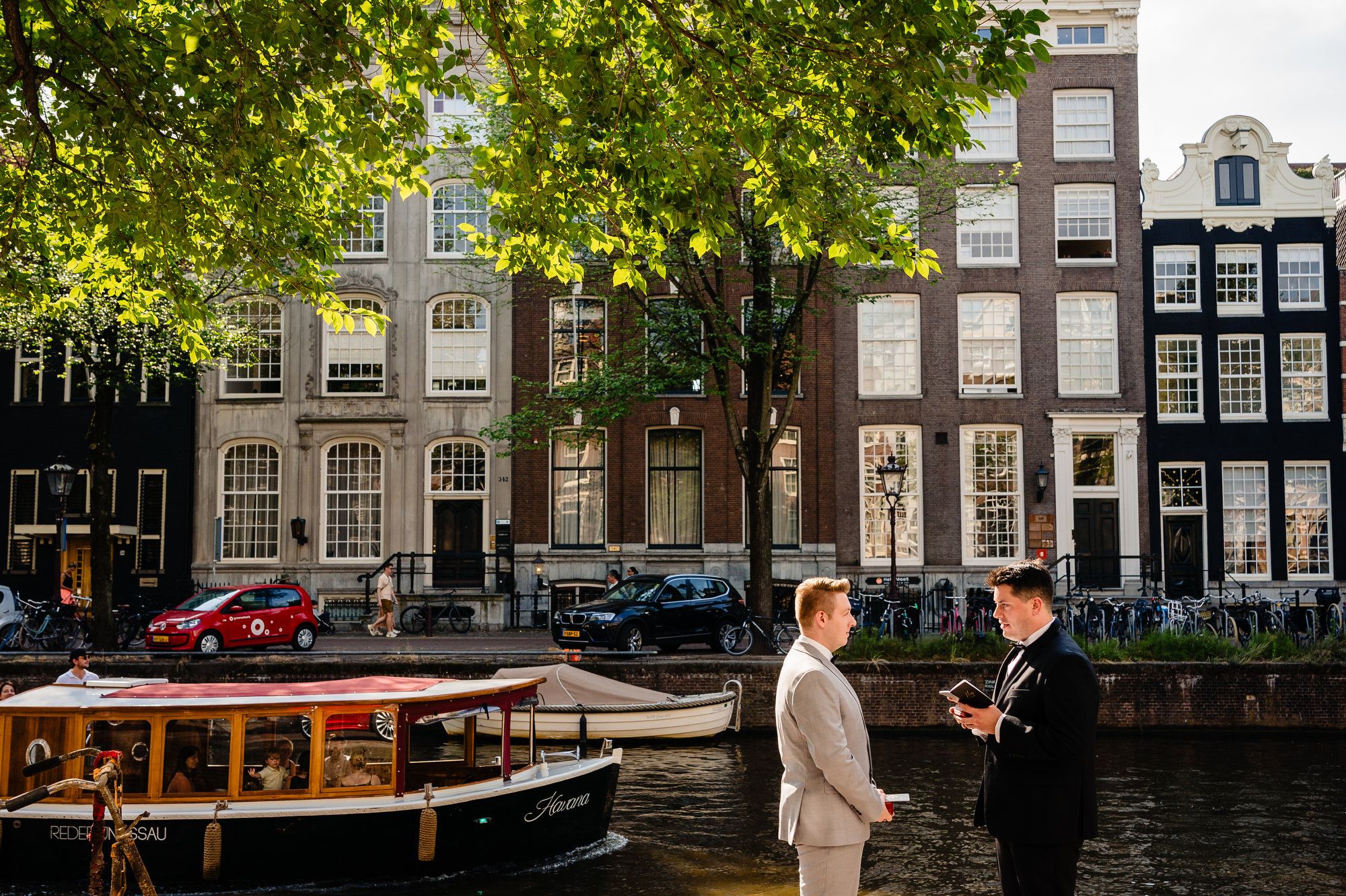 LGBTQIA+ couple say their vows during their elopement with Dutch house on the background.