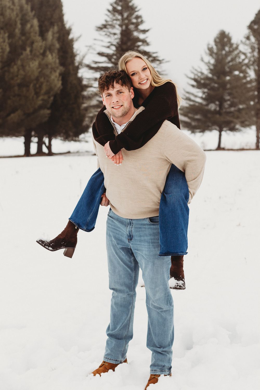 Snow engagement session in Maine with candid couple moment in natural winter light
