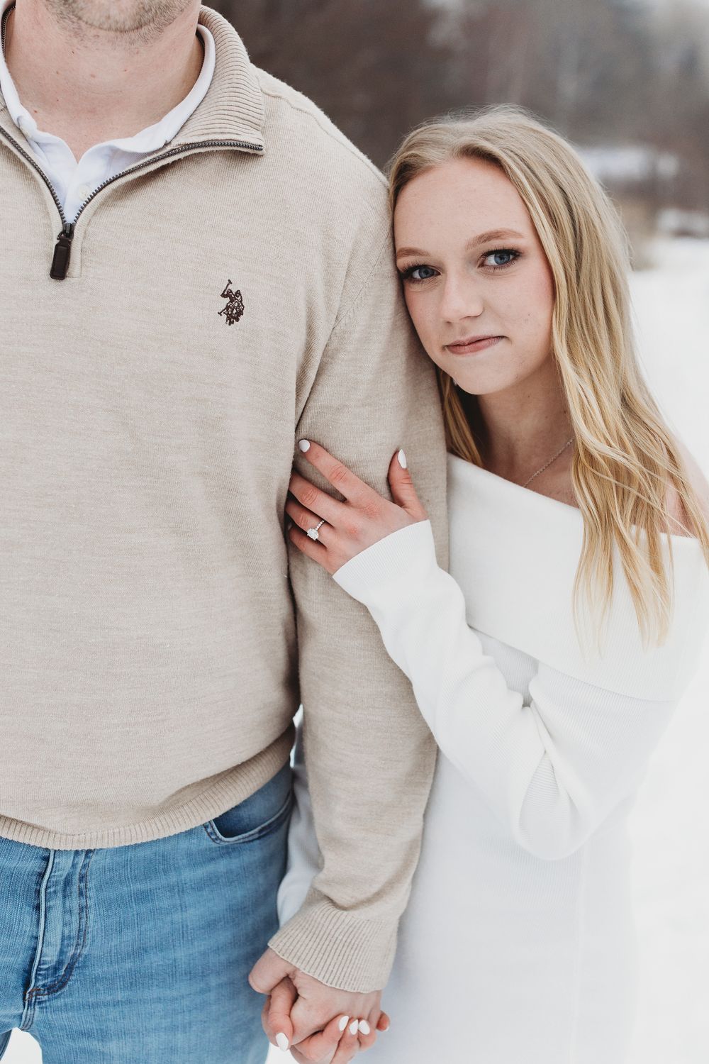 Cozy winter engagement portrait in Maine with couple wrapped in blankets in the snow