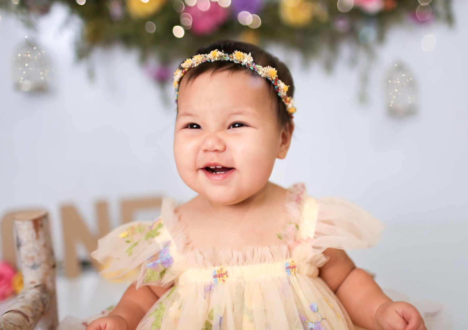 Baby girl in studio for first birthday session cake smash session